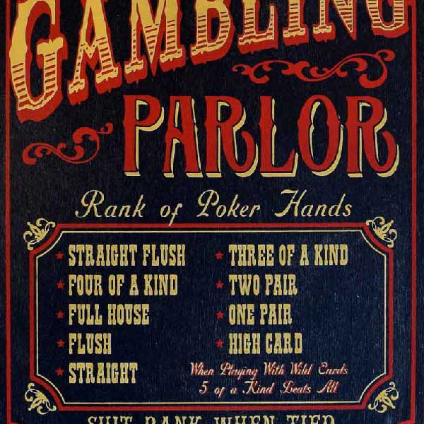close up of rank of poker hands on wood sign