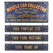 Blue and gold sign for Muscle Car Collector; raised image of car; hanging boards with car names