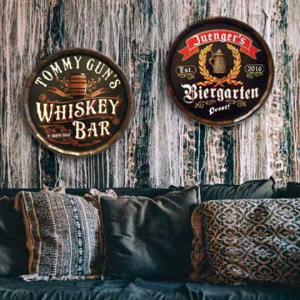 Two quarter barrel signs above couch: Whiskey Bar and Biergarten.