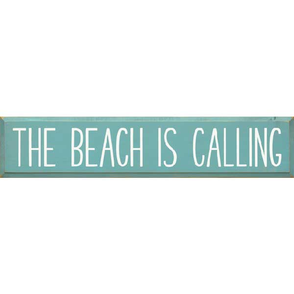 wood sign "The Beach Is Calling"