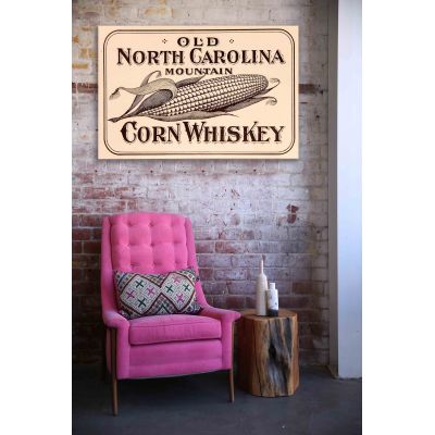 Old North Carolina whiskey wood sign above a chair
