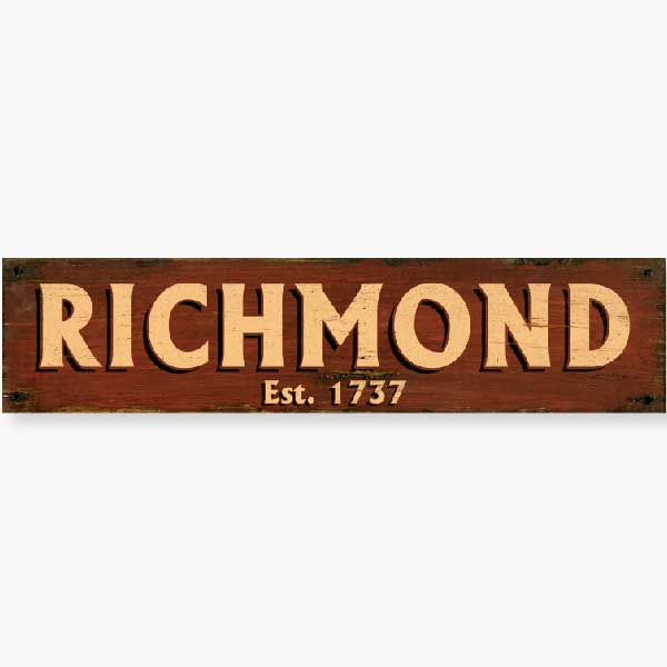 weathered red wood sign for any town