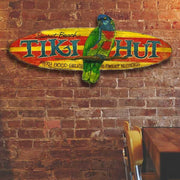 surf board shaped tiki hut wood sign for beach side restaurant