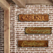 Three pack of vintage wood signs with wine varietal name: Chardonnay, champagne, and cabernet