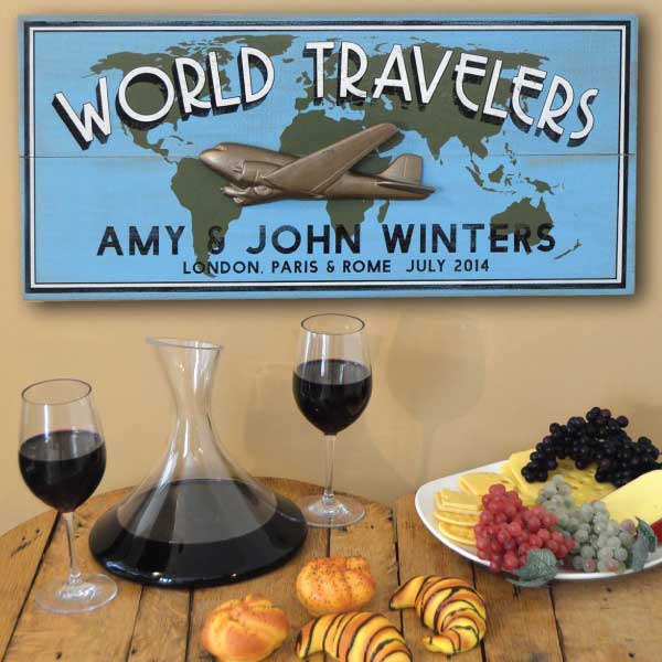 Wood sign for World Traveler with world map and 3D relief of a DC3 airplane hung on a wall