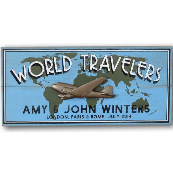 Wood sign for World Traveler with world map and 3D relief of a DC3 airplane; blue with white lettering