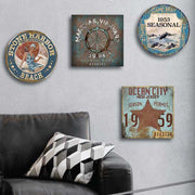 Four season beach tags hanging on gray wall above a leather couch