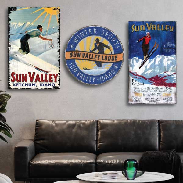 collection of Sun Valley decorations shown above a dark leather couch; ski condo decorations