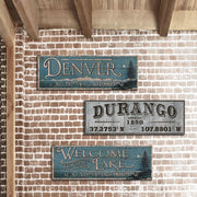 Town name signs on brick wall