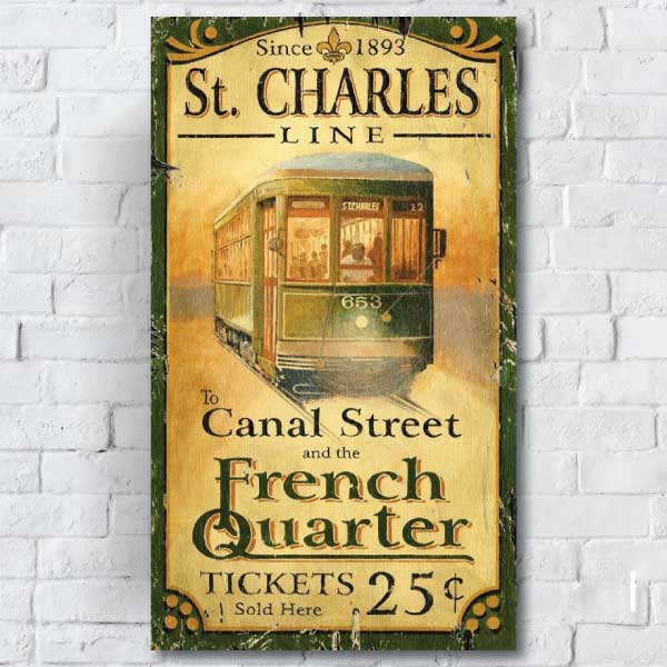 French Quarter and Canal Street - St Charles Line Street Car vintage advertisement hung on a white brick wall
