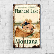 Retro sign of canoe on Flathead Lake, Montana. White brick background.