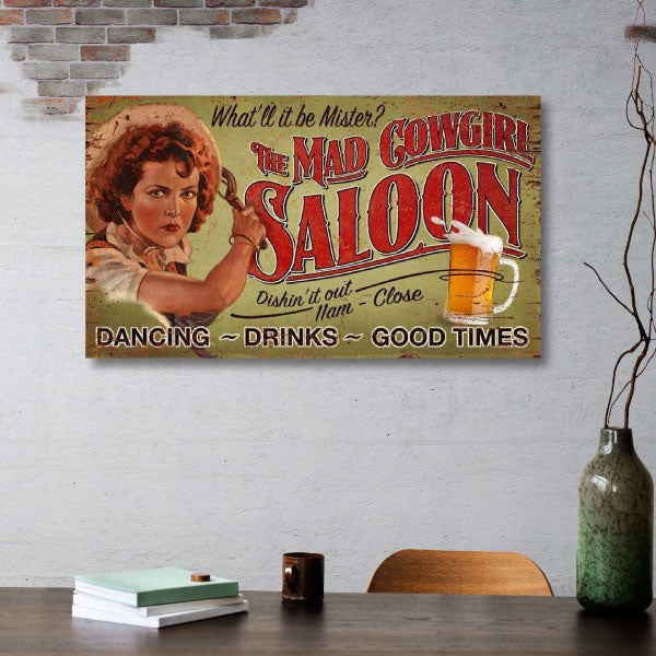Mad Cowgirl Saloon ad above desk with beer