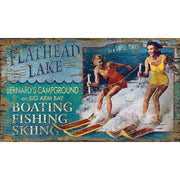 Vintage wood sign with retro advertisements for campground, boating and fishing on a waterski lake.