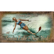 vintage wood sign with women waterskiing on lake