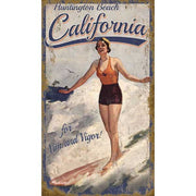 early century surfer at Huntington Beach, California. Old wood sign