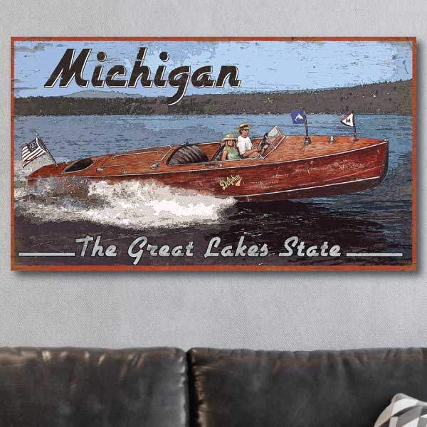 Classic wood boat; Michigan; The Great Lakes State; Vintage wood sign on grey wall above a leather couch