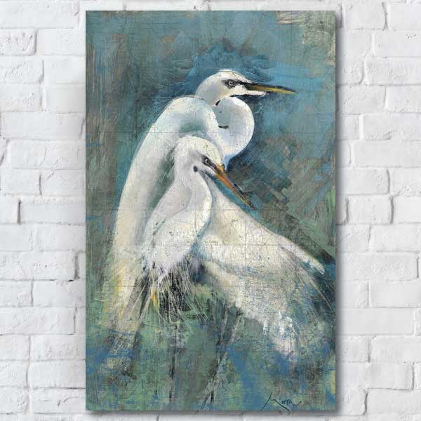 image of a pair of white Egrets huddled together hung on a white brick wall