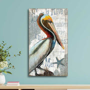 coastal wall art of pelican with sea and floating French words behind. Vintage wood sign