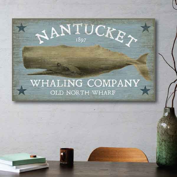 Vintage sign for Nantucket Whaling Company. Image of whale with 4 stars.